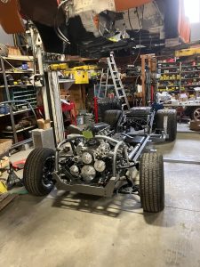 Barrys Custom Fab completed chassis orange top being lowered down
